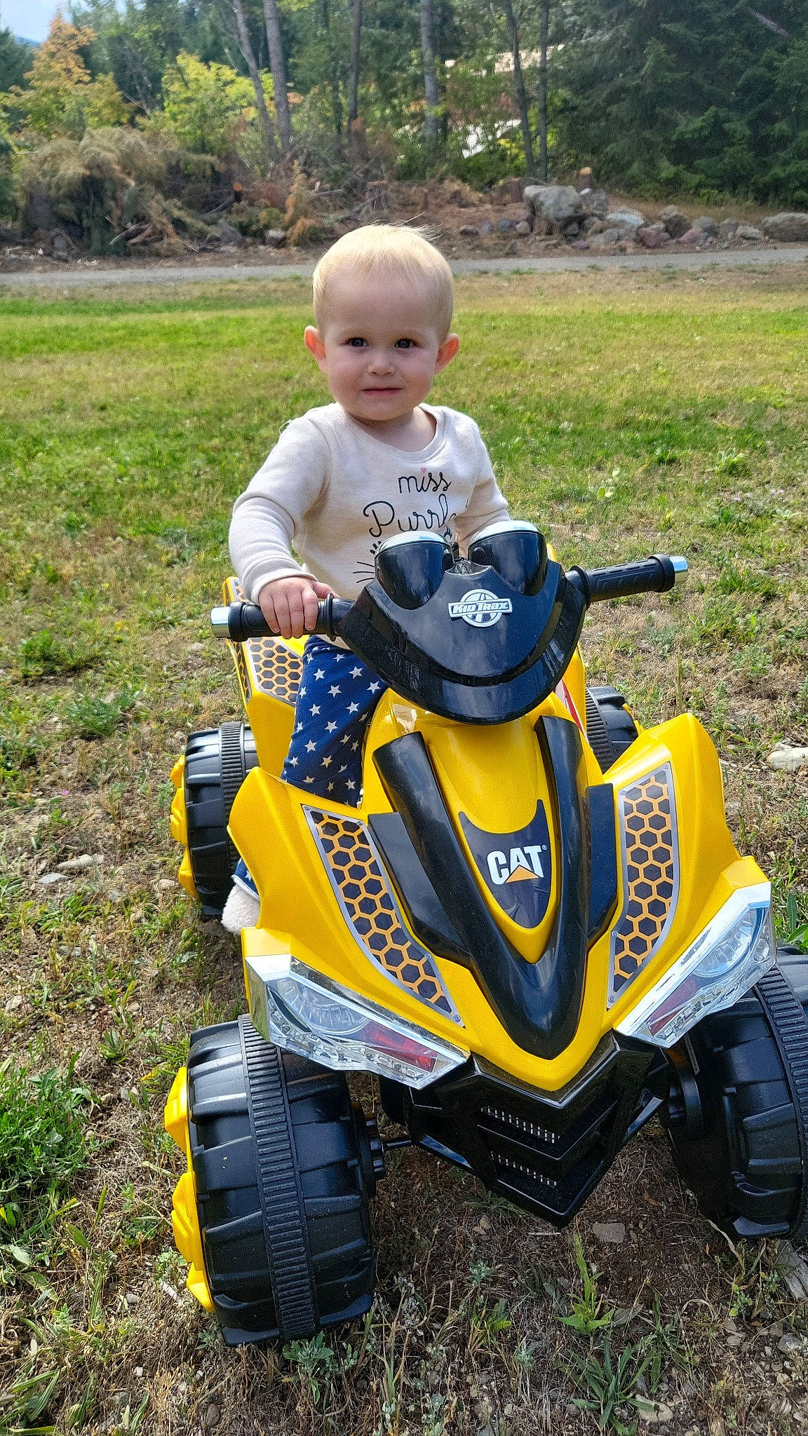 Blakelyn is registered to the contest to win money with this photo: all_terrain_vehicle, auto_part, automotive_design, automotive_exterior, automotive_tire, automotive_wheel_system, grass, grassland, joy, motor_vehicle, motorsport, person, racing, recreation, rim, soil, sports, tire, toddler, tree