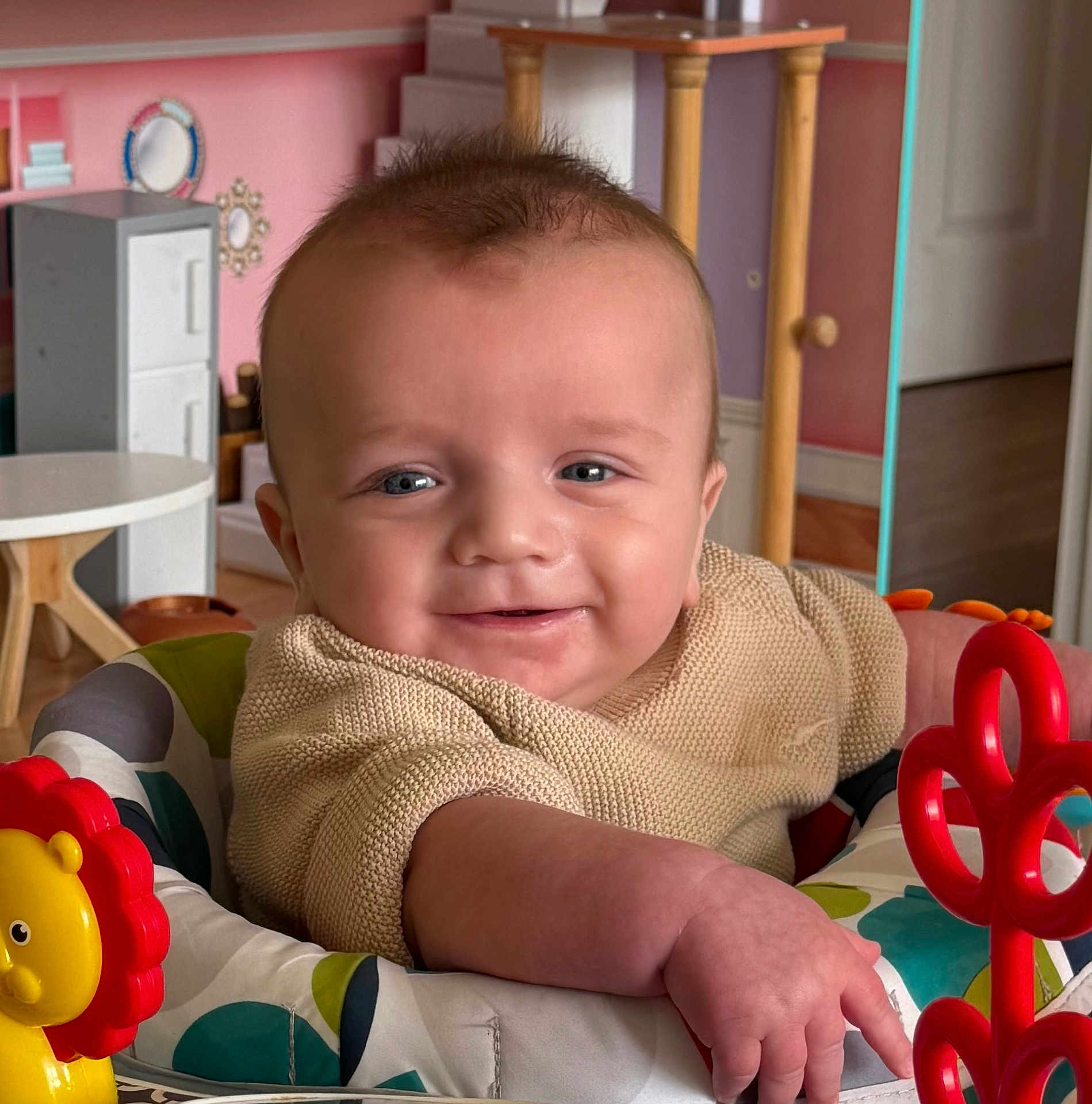 Aaron joined the competition — help win amazing prizes! baby, smiling, infant, child, toy, baby_seat, indoor, furniture, colorful, playful, face, person, clothing, room, pastel, baby_toys, happy, cute, portrait, home
