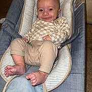 Cooper joined the competition — help win amazing prizes! baby, infant, smile, baby_seat, clothing, checkered_pattern, foot, hand, face, cushion, fabric, indoor, comfort, child, person, cute, relaxing, happy, skin, head