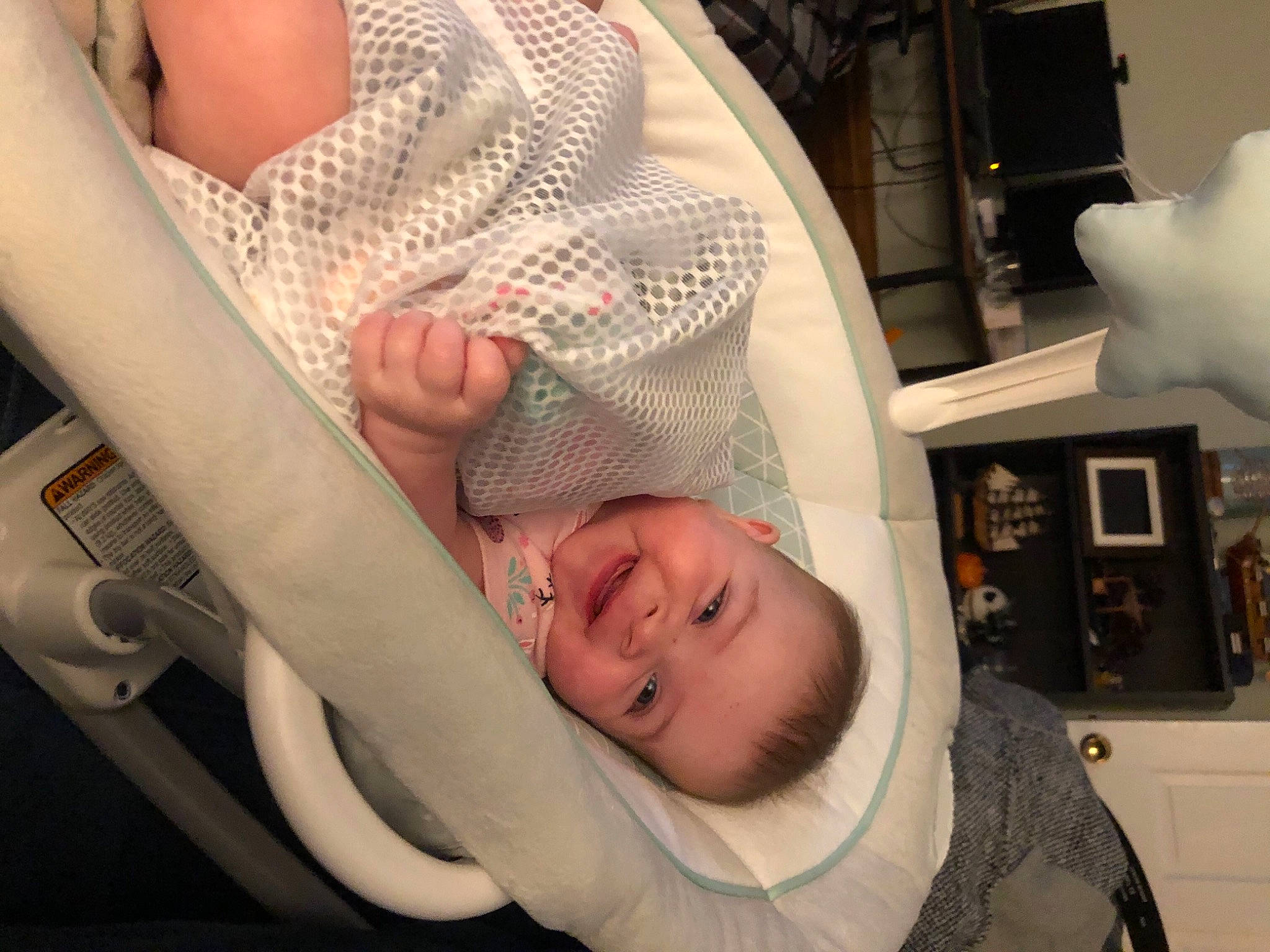 June is registered to the contest to win money with this photo: arm, auto_part, baby, baby_carriage, baby_products, baby_toddler_clothing, child, comfort, elbow, eyebrow, fun, gesture, health_care, human_body, joy, mouth, person, skin, smile, thumb