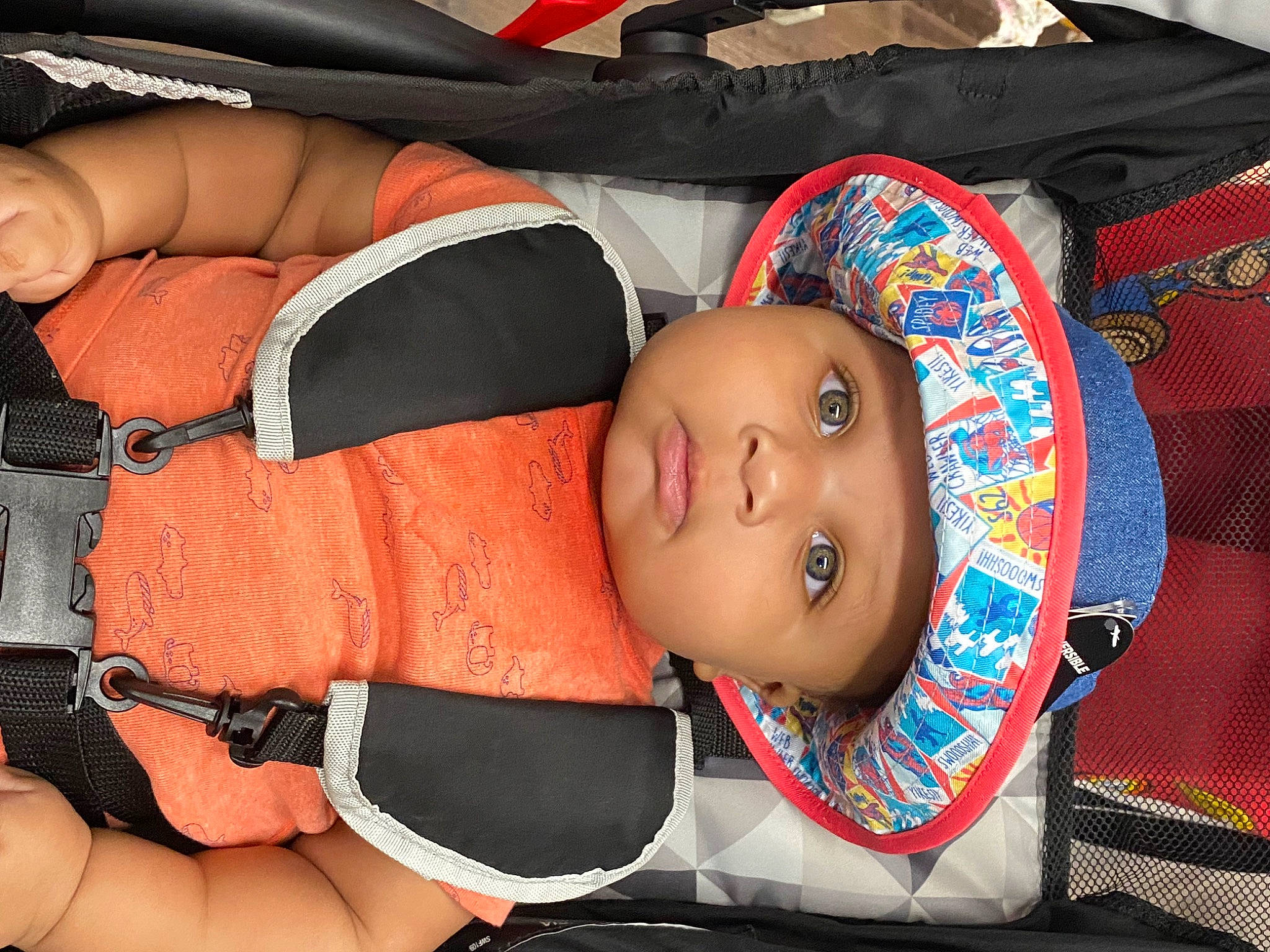 King is registered to the contest to win money with this photo: baby, baby_carriage, baby_products, baby_safety, baby_sleeping, baby_toddler_clothing, car_seat, carmine, cheek, chest, child, comfort, fashion_accessory, headwear, orange, person, personal_protective_equipment, product, thigh, thumb