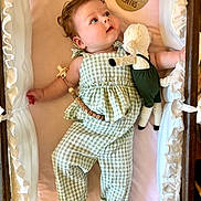 Rosemary joined the competition — help win amazing prizes! baby, bed, child, clothing, crib, cute, fabric, five_months, gazing, green_outfit, indoors, infant, milestone, person, plush_toy, portrait, resting, smiling, soft_toy, wooden_plaque