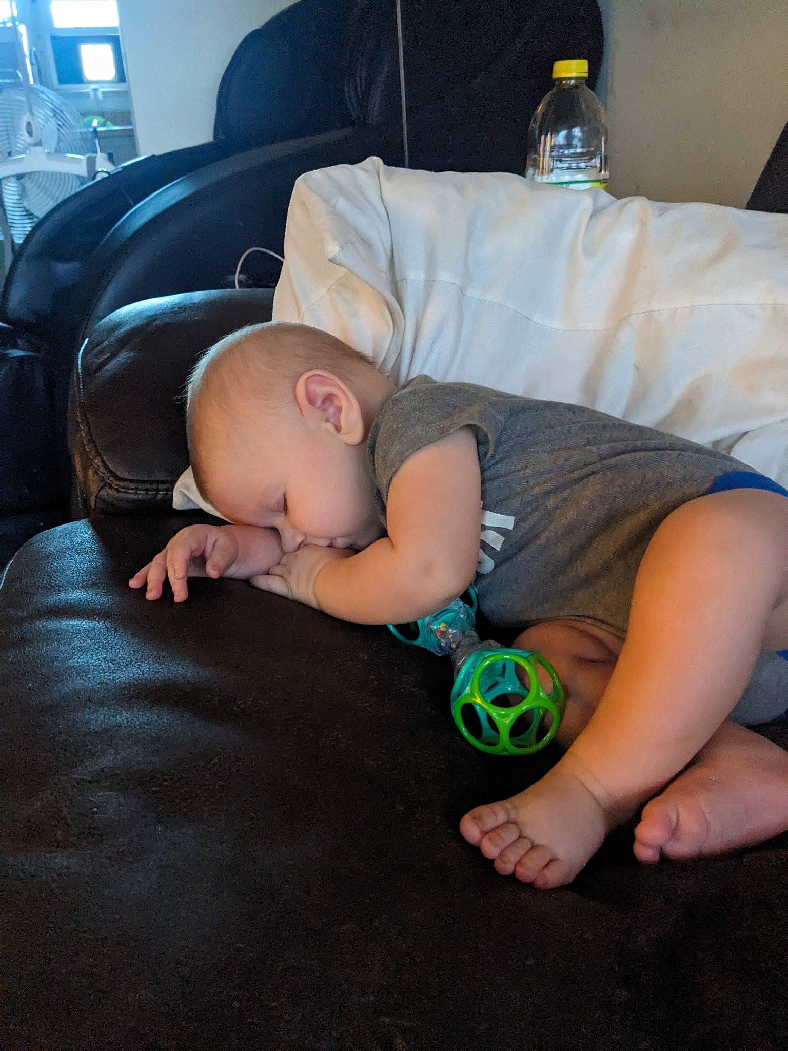Oliver joined the competition — help win amazing prizes! audio_equipment, baby, child, comfort, couch, finger, flooring, foot, fun, grass, human_body, human_leg, knee, leg, linens, person, sitting, thigh, toddler, water_bottle