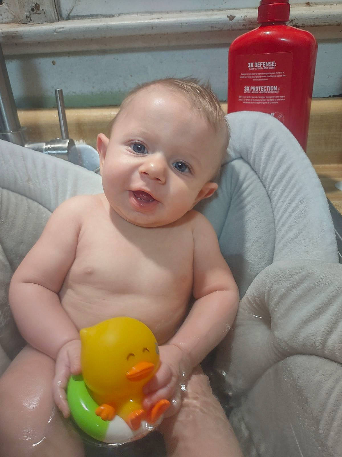 Oliver is registered to the contest to win money with this photo: baby, baby_bathing, bath_toy, bathing, cheek, chest, eye, finger, gas, head, human_body, mouth, person, plastic_bottle, product, skin, smile, toddler, toy, water