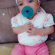 Tehlani Milele is registered to the contest to win money with this photo: baby, pacifier, headband, bow, pink_pants, white_socks, bib, couch, blanket, sparkle_effect, infant, sitting, cute, child, hands, face, clothing, indoor, portrait, soft_lighting