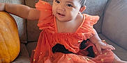 Havenayha joined the competition — help win amazing prizes! baby, child, orange_dress, headband, pumpkin, couch, indoor, cute, smiling, sitting, foot, hand, fabric, star_pattern, person, face, home, holiday, festive, decor