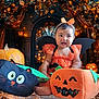 Havenayha is registered to the contest to win money with this photo: baby, child, halloween, costume, pumpkin, jack_o_lantern, orange, black, bat_wings, headband, plush_toy, autumn, leaves, doorway, lights, smile, festive, holiday, outdoor, decorations