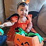Havenayha joined the competition — help win amazing prizes! baby, child, halloween, costume, orange_dress, headband, bat_wings, pumpkin_basket, plush, couch, indoor, smiling, cute, holiday, festive, decor, person, sitting, happy, soft_toy