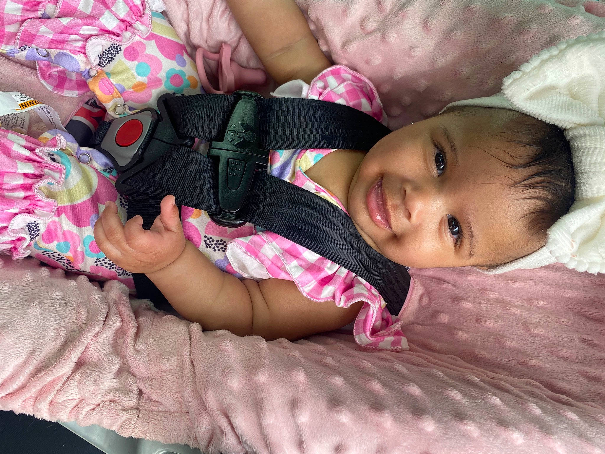 Kaylani is registered to the contest to win money with this photo: baby, baby_products, baby_toddler_clothing, cheek, child, comfort, dress, eye, grass, hand, human_body, joy, linens, nail, pattern, person, pink, sitting, skin, sleeve