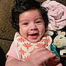 Azalea joined the competition — help win amazing prizes! baby, bib, blanket, closeup, curly_hair, expression, face, hand, happy, indoor, infant, pacifier, person, pink_clothing, plush_toy, portrait, smiling, soft_toy, toy, young_child