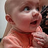 baby, infant, closeup, face, hands, orange_clothing, person, child, cute, expression, indoor, skin, eyes, portrait, newborn, adorable, human, young, clasped_hands, soft_lighting