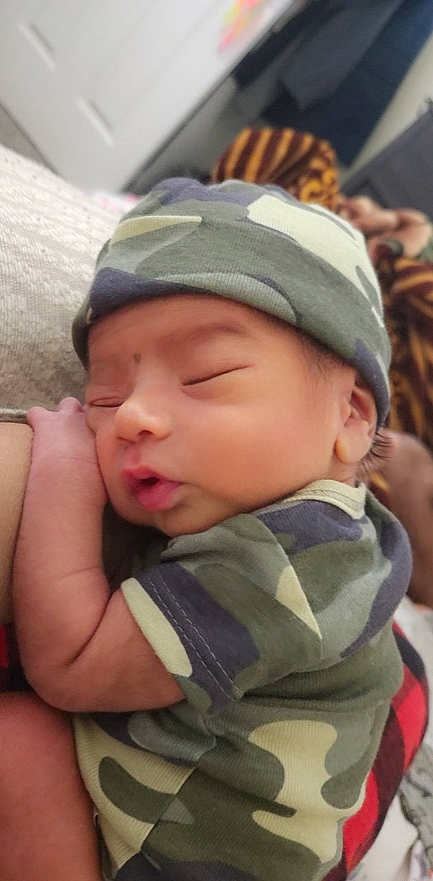 Vihan Nathan Khalil is registered to the contest to win money with this photo: baby, baby_toddler_clothing, cap, cheek, child, comfort, cool, eyelash, fashion_accessory, forehead, fun, grass, happy, headwear, lip, mouth, nose, person, product, sitting