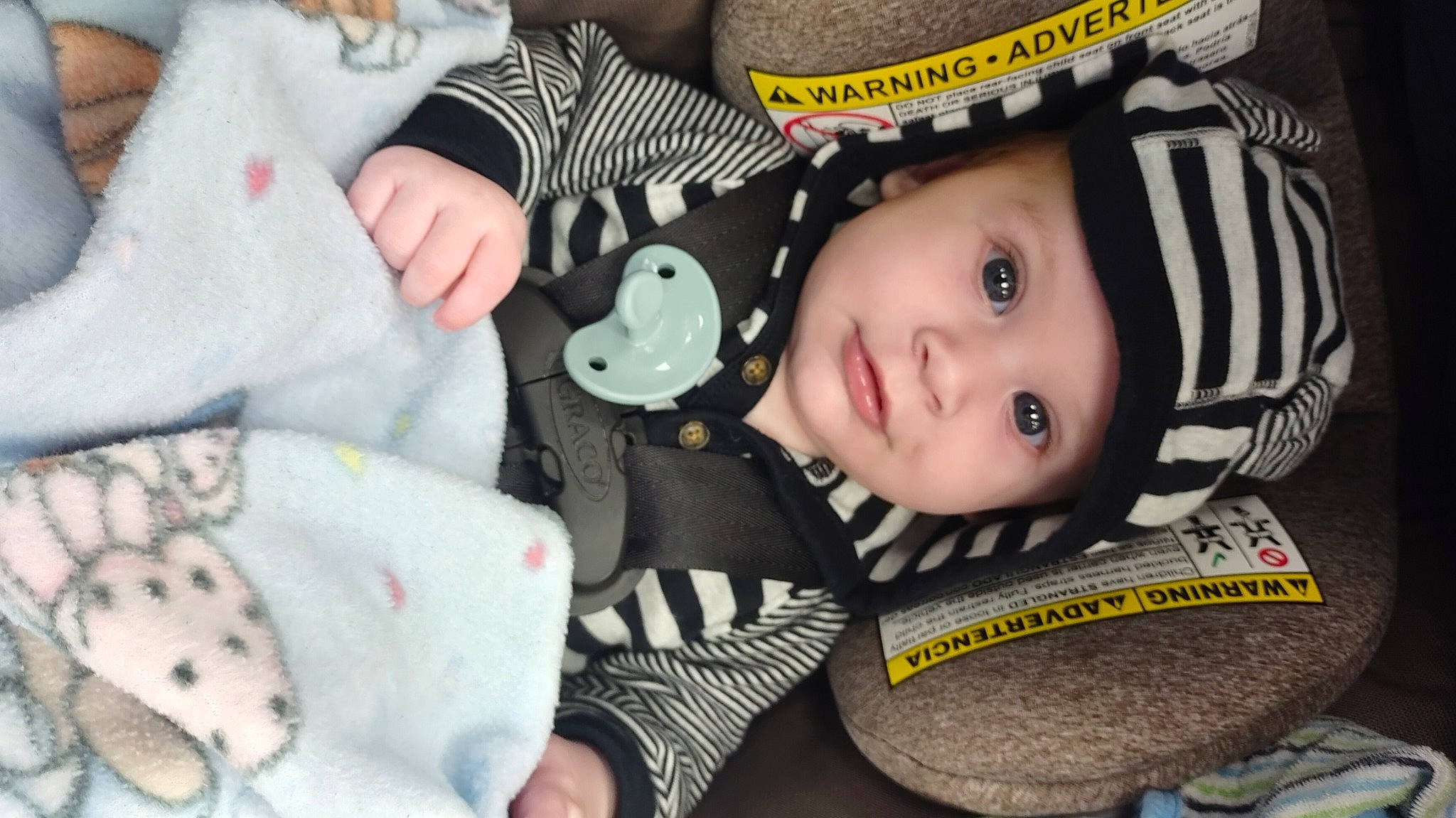 Owen is registered to the contest to win money with this photo: baby, baby_carriage, baby_products, baby_toddler_clothing, car_seat, carmine, cheek, child, eyelash, fashion_accessory, flash_photography, happy, headgear, headwear, linens, nail, pattern, person, skin, smile