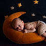 baby, infant, pillow, crescent_moon, stars, soft_toys, sleepy, resting, dark_background, nursery, cute, child, newborn, cozy, fabric, bedtime, peaceful, small, lying_down, indoors
