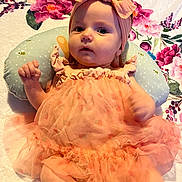 Kennidi joined the competition — help win amazing prizes! baby, infant, tutu, headband, flower_pattern, blanket, pillow, cute, portrait, clothing, pink, orange, person, child, smile, happy, indoors, soft_texture, baby_girl, toddler