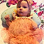 baby, infant, tutu, headband, flower_pattern, blanket, pillow, cute, portrait, clothing, pink, orange, person, child, smile, happy, indoors, soft_texture, baby_girl, toddler