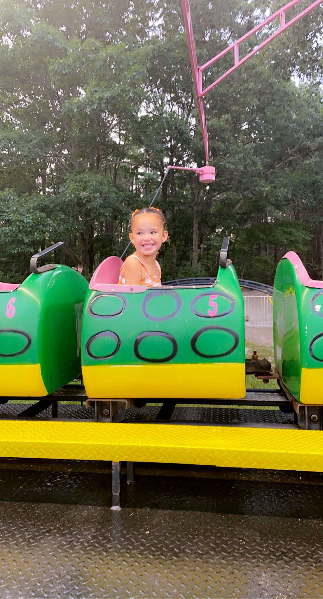 Elianna is registered to the contest to win money with this photo: chute, city, fun, games, grass, green, happy, human_settlement, inflatable, joy, leisure, motor_vehicle, natural_environment, outdoor_play_equipment, person, plant, play, playground, recreation, smile