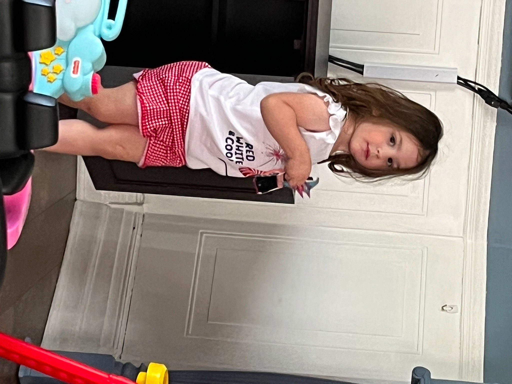 Sophia is registered to the contest to win money with this photo: arm, automotive_design, automotive_exterior, chest, door, elbow, fun, human_leg, joint, knee, machine, motor_vehicle, person, shorts, sitting, sportswear, t_shirt, thigh, tire, vehicle_door