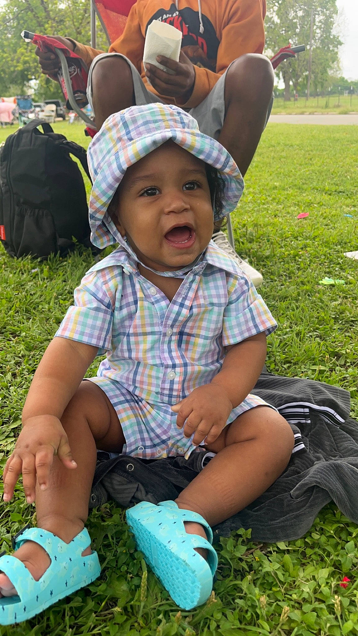 Zavien is registered to the contest to win money with this photo: botany, cap, fun, grass, grass_family, green, happy, hat, headwear, lawn, leaf, leisure, people_in_nature, person, photograph, plant, sneakers, summer, sun_hat, toddler