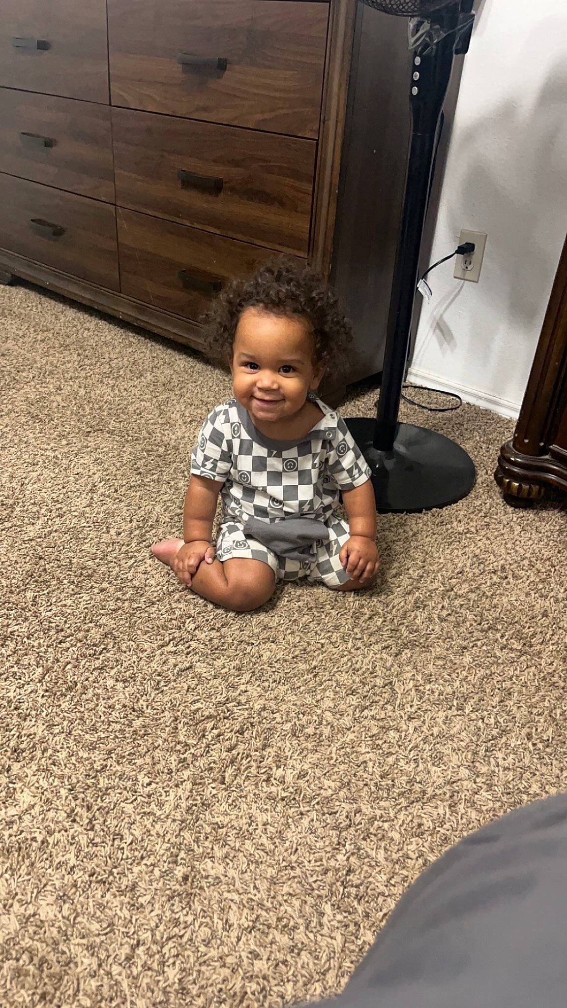 Zavien is registered to the contest to win money with this photo: asphalt, baby, baby_toddler_clothing, cabinetry, child, drawer, floor, flooring, foot, fun, grass, happy, hardwood, human_leg, joy, person, road_surface, sitting, smile, tints_and_shades