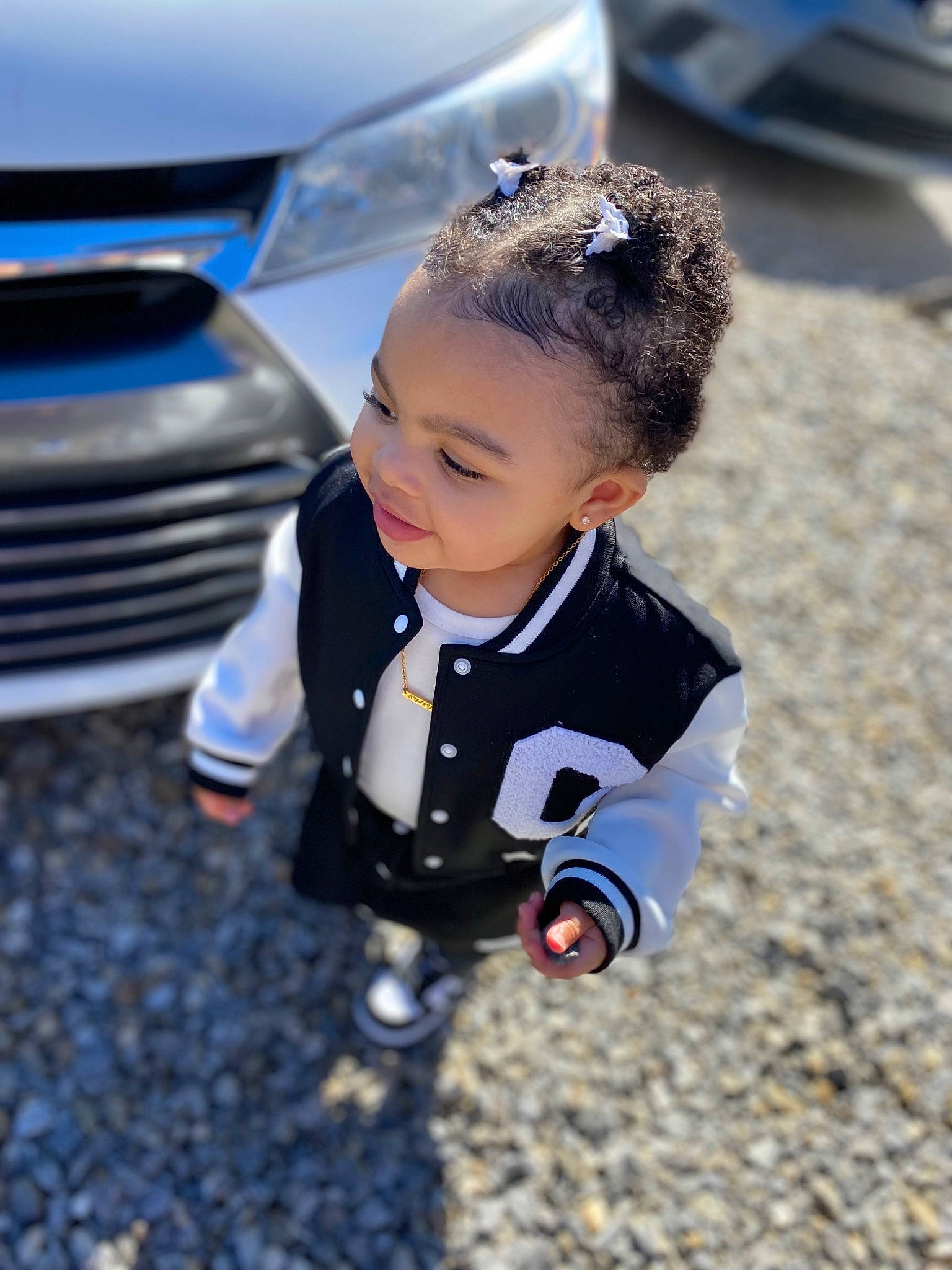Kyliyah joined the competition — help win amazing prizes! asphalt, automotive_design, automotive_exterior, automotive_lighting, automotive_tire, bumper, car, electric_blue, face, grille, happy, headlamp, hood, motor_vehicle, person, personal_luxury_car, rim, smile, toddler, vehicle