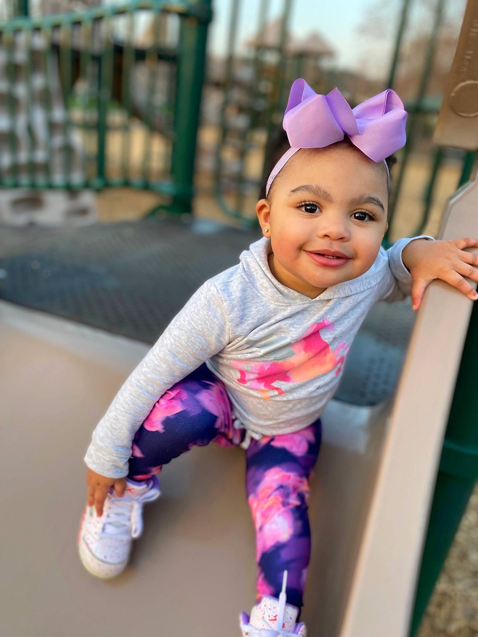 Kyliyah is registered to the contest to win money with this photo: baby, baby_products, baby_toddler_clothing, cheek, child, face, fun, grass, happy, joy, leisure, magenta, person, pink, play, purple, recreation, sitting, sleeve, smile