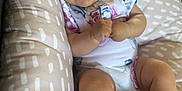 Kate joined the competition — help win amazing prizes! baby, infant, smile, cushion, floral_onesie, comfort, cute, chubby_cheeks, relaxing, indoors, soft_fabric, pattern, skin, person, happy, child, closeup, young, sitting, babywear