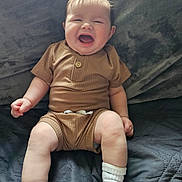 Colsen joined the competition — help win amazing prizes! baby, blanket, brown_outfit, child, comfort, cozy, cute, fun, happy, human, indoor, infant, laughing, person, portrait, sitting, smiling, soft_lighting, white_socks, young_child