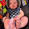 baby, car_seat, checkered_pattern, child, closeup, colorful, comfort, cute, expression, face, feet, hands, indoor, infant, onesie, playful, portrait, seat_belt, toys, warning_label