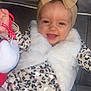 Myla participe au concours pour gagner de l'argent avec cette photo : baby, child, smile, headband, bow, vest, toy, couch, patterned_dress, happy, indoor, person, furniture, plush, clothing, toddler, cute, face, sitting, bright