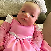Ellie joined the competition — help win amazing prizes! baby, infant, tiara, pink_dress, mesh_sleeves, princess, cute, portrait, child, person, indoor, couch, blanket, clothing, headwear, young, small_hands, soft_light, relaxed, adorable