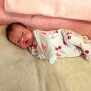 Ellie joined the competition — help win amazing prizes! newborn, baby, infant, sleepwear, blanket, pink, white, seashell_pattern, smiling, lying_down, soft_texture, cozy, cute, child, portrait, indoors, resting, happy, clothing, face