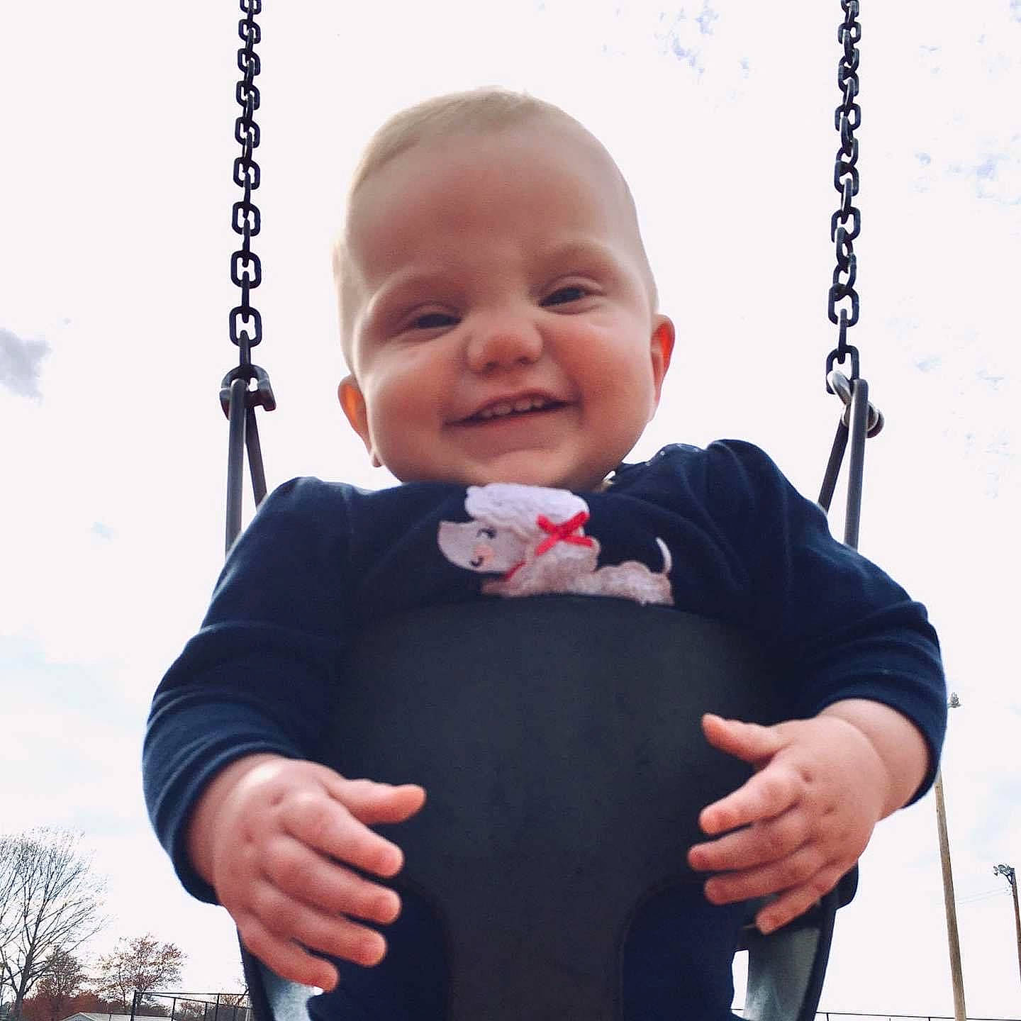 Lynleigh is registered to the contest to win money with this photo: baby_toddler_clothing, black, cheek, chin, cloud, eye, face, facial_expression, hand, happy, human_body, joint, joy, person, shoulder, skin, sky, sleeve, smile, standing
