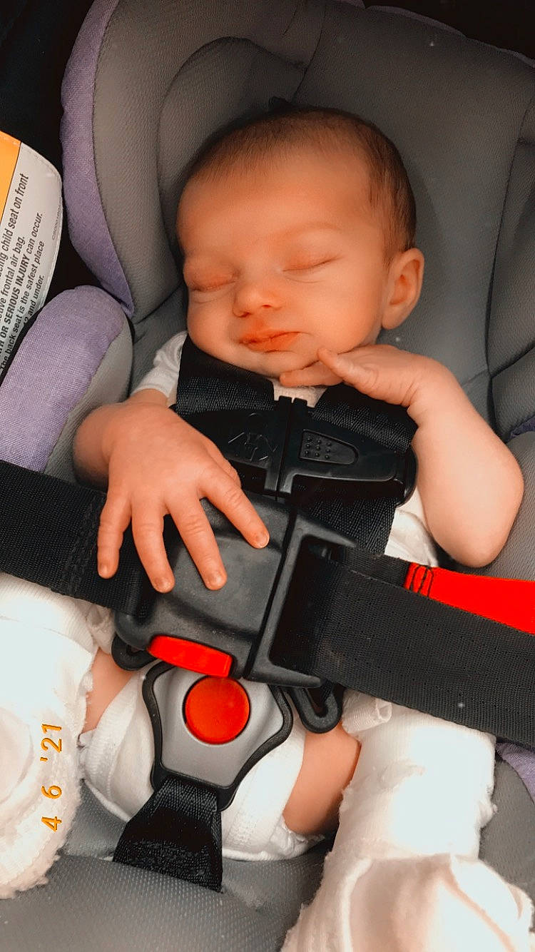 Aleigha is registered to the contest to win money with this photo: arm, baby, baby_toddler_clothing, cheek, comfort, finger, hand, human_body, joint, mouth, muscle, orange, organ, person, product, seat_belt, skin, textile, thumb, toddler