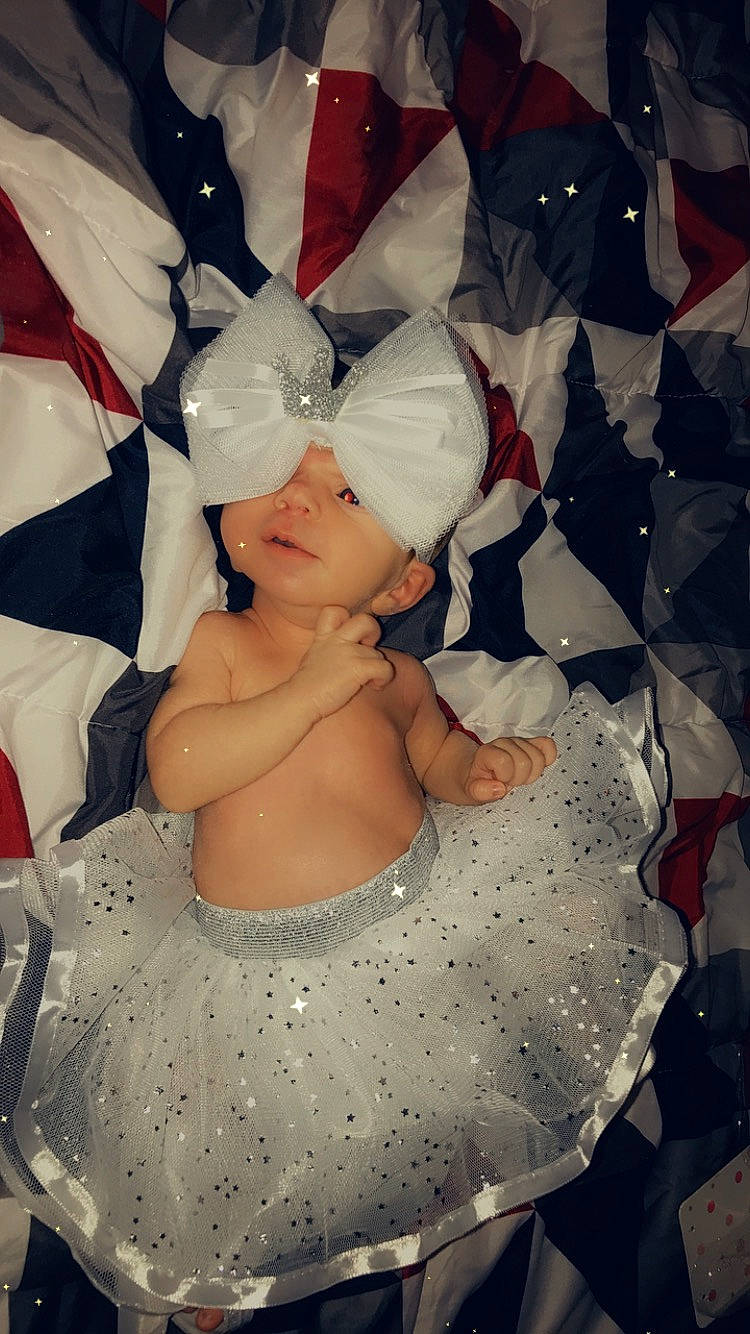 Aleigha is registered to the contest to win money with this photo: art, baby, baby_products, baby_toddler_clothing, beauty, carmine, child, design, embellishment, event, fashion_accessory, fictional_character, hat, headgear, headwear, pattern, person, pink, product, sleeve