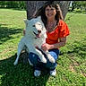 Sophia joined the competition — help win amazing prizes! woman, dog, white_dog, tree, grass, outdoor, smiling, sunny, casual_clothing, orange_top, jeans, sneakers, pet, nature, happy, friendship, animal, leisure, daylight, park