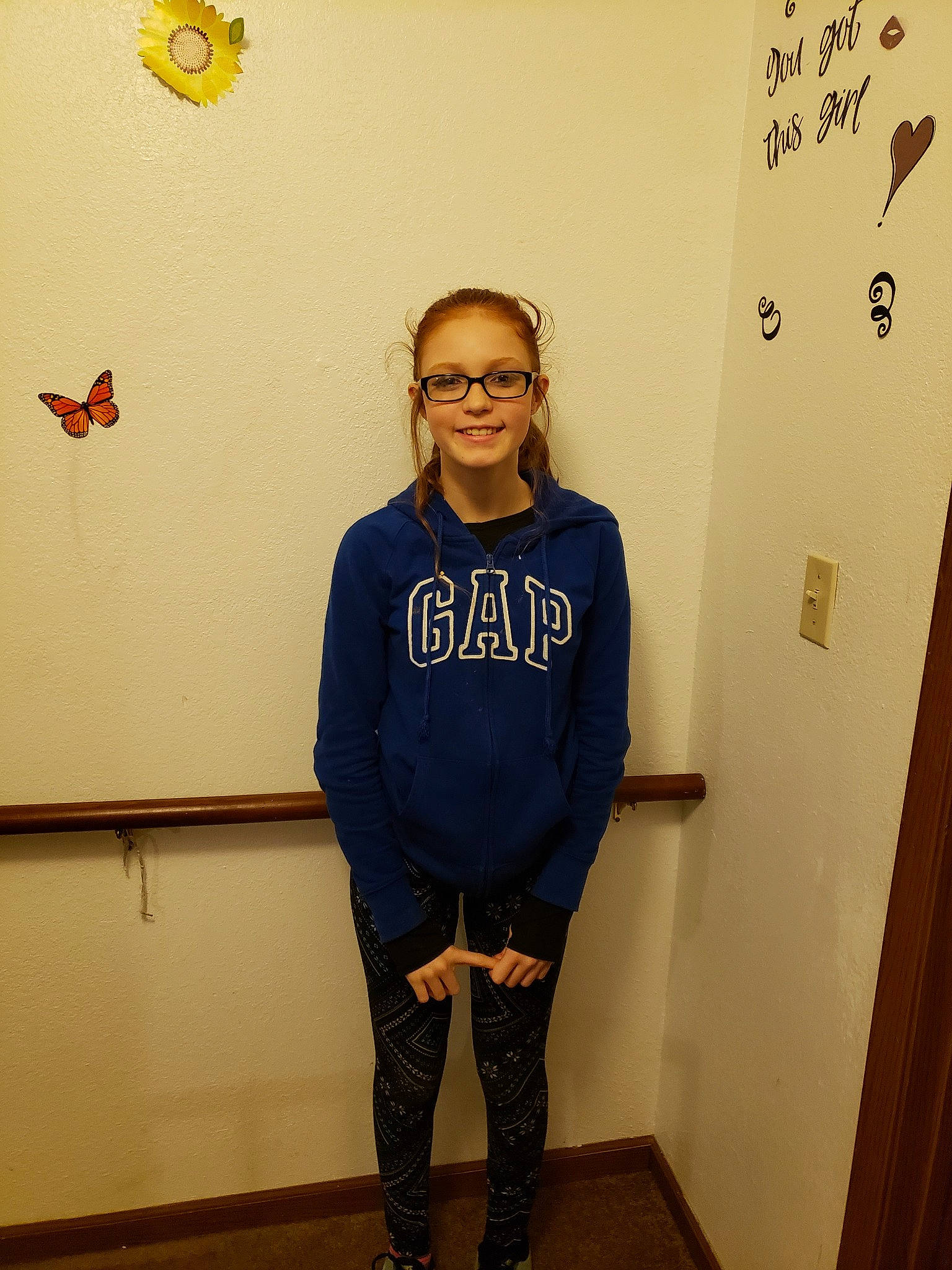 Charity is registered to the contest to win money with this photo: blue, clothing, cool, design, facial_hair, fashion_accessory, footwear, fun, girl, glasses, jeans, joy, outerwear, pattern, person, shoulder, smile, standing, t_shirt, top