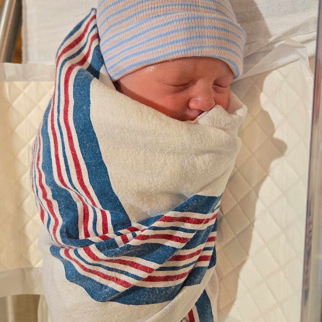 Blake joined the competition — help win amazing prizes! newborn, baby, hospital, blanket, striped, hat, sleeping, bassinet, infant, wrapped, bed, medical, patient, cute, child, person, indoors, resting, soft, peaceful