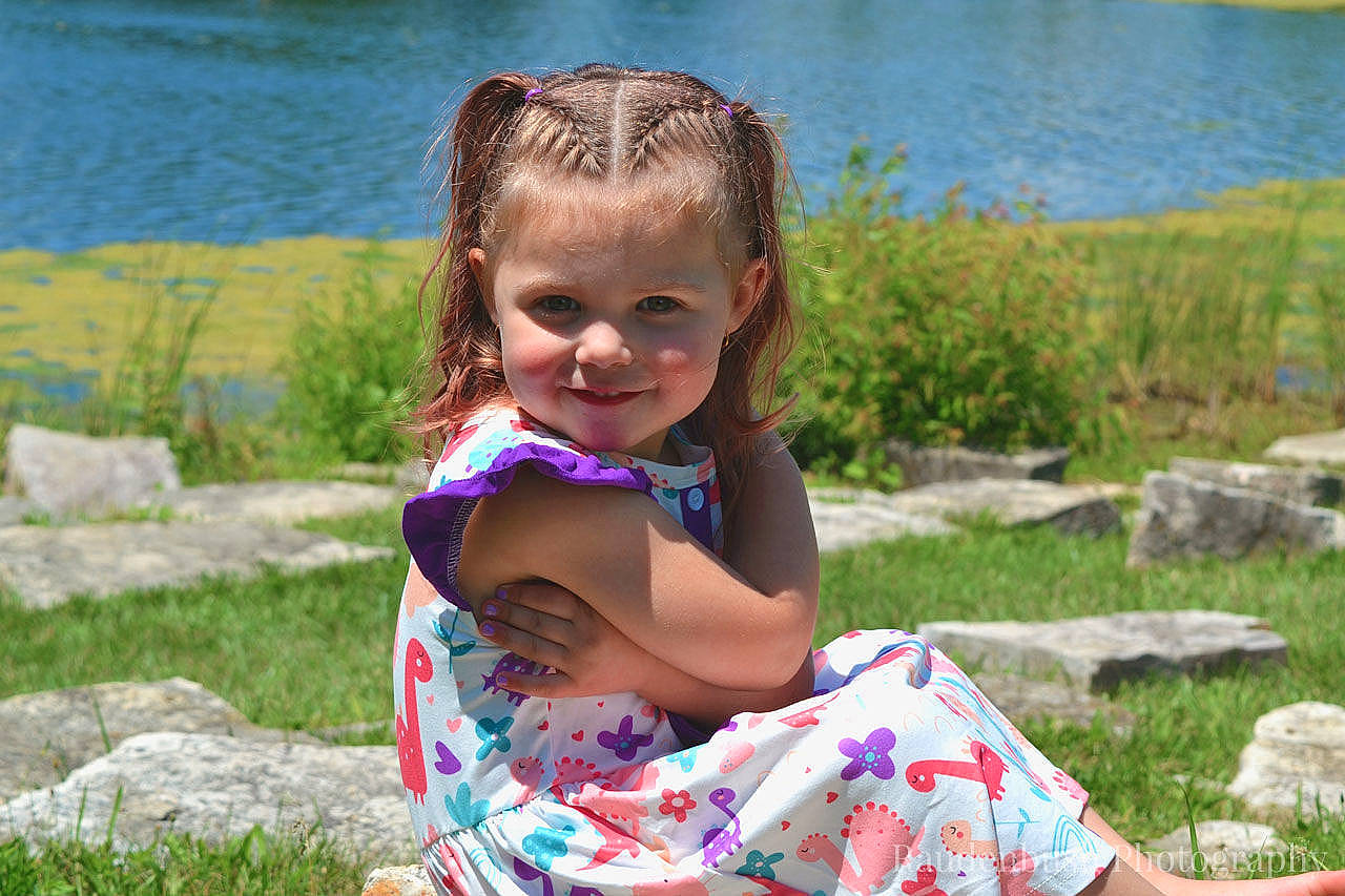 Daisy Jo joined the competition — help win amazing prizes! child, face, fun, grass, hair, happy, joy, lake, landscape, leisure, people, people_in_nature, person, plant, recreation, sitting, smile, summer, toddler, tree
