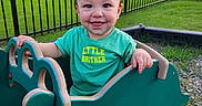 Harper joined the competition — help win amazing prizes! baby, child, evening_light, face, fence, grass, green_shirt, house, lawn, little_brother, outdoor, playground, playtime, portrait, rocking_toy, smiling, suburban, toddler, toy, train