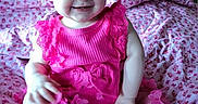 Aliyah joined the competition — help win amazing prizes! baby, blanket, butterfly_pattern, candid, child, cute, face, feet, hands, happy, headband, indoor, infant, one_person, patterned_blanket, pink_clothing, portrait, sitting, smiling, young_child