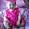 baby, child, smiling, pink_clothing, headband, sitting, blanket, indoor, cute, happy, infant, patterned_blanket, butterfly_pattern, portrait, one_person, young_child, face, hands, feet, candid
