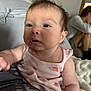 Clementine joined the competition — help win amazing prizes! baby, infant, pink_clothing, drool, cute, portrait, indoor, person_in_background, blurred_background, soft_light, curious_expression, tousled_hair, sitting, fabric_texture, skin, face, arm, real_people, cozy, casual
