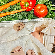 Jessie is registered to the contest to win money with this photo: baby, bow, carrots, child, closeup, cute, food, fresh_food, fuzzy_jacket, hand, headband, healthy, indoors, infant, kale, pacifier, sleeping, tomatoes, vegetables, white_clothing