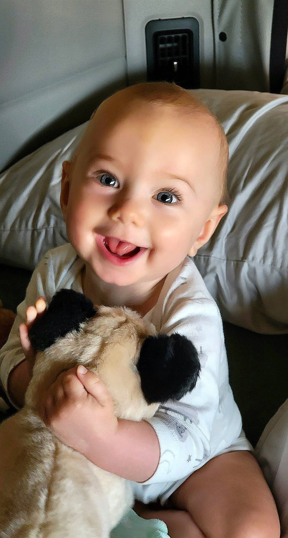 Aiyana is registered to the contest to win money with this photo: baby, baby_toddler_clothing, car_seat, child, comfort, companion_dog, finger, fur, gesture, happy, joy, linens, mammal, paw, person, sitting, skin, smile, thumb, toddler