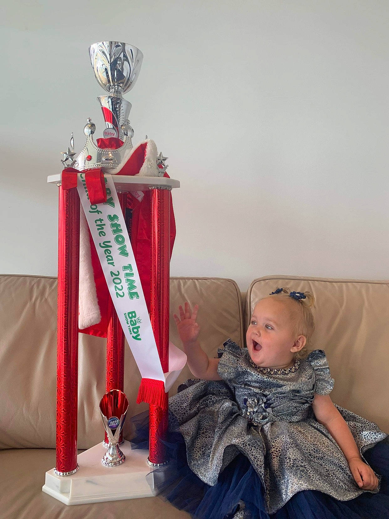Savannah is registered to the contest to win money with this photo: baby_toddler_clothing, carmine, chair, christmas, christmas_decoration, christmas_ornament, comfort, couch, event, fictional_character, fun, fur, holiday, interior_design, lap, pattern, person, room, sitting, toddler