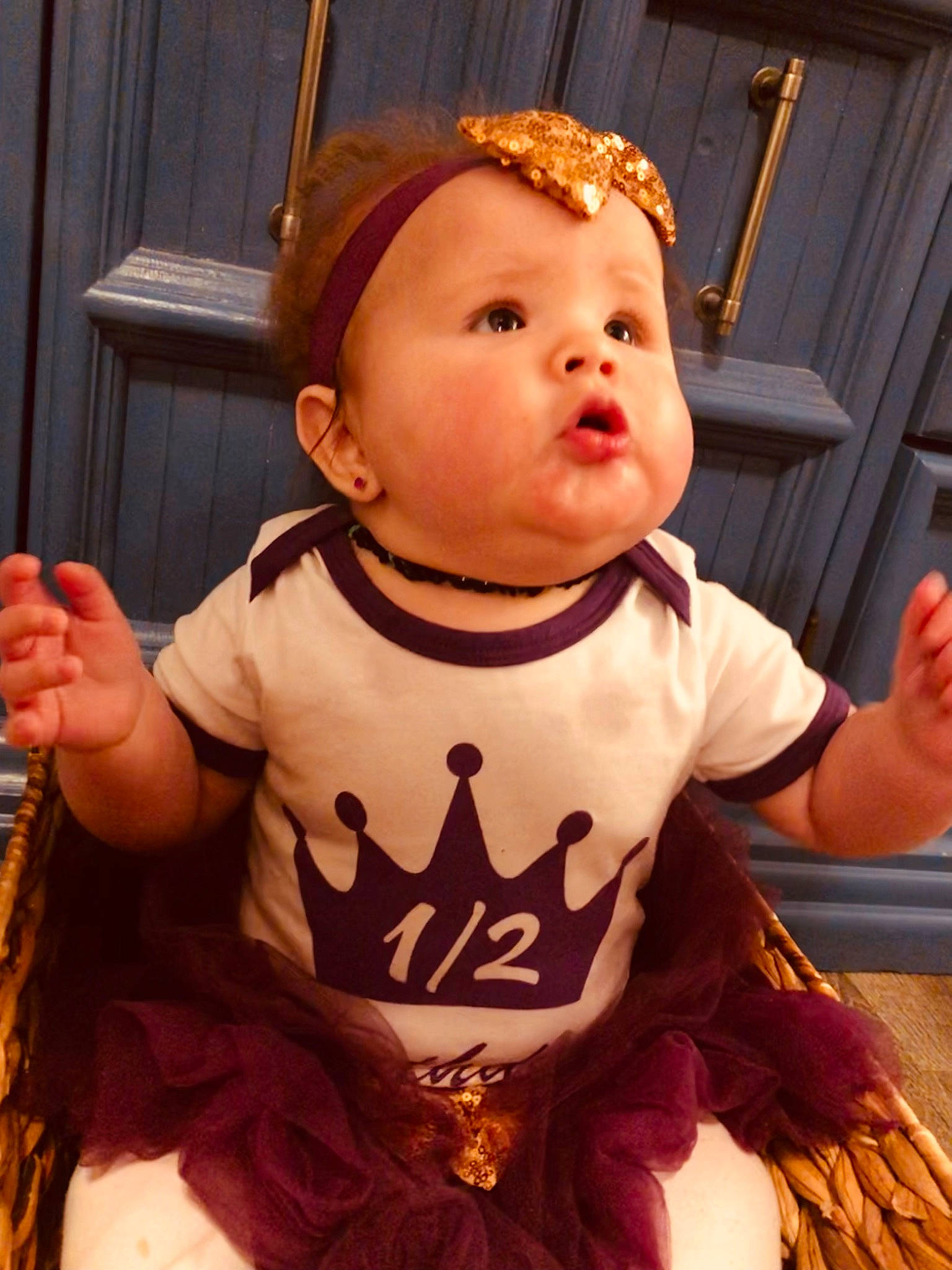 Veronica is registered to the contest to win money with this photo: arm, baby, baby_toddler_clothing, chair, cheek, child, cool, finger, fun, gesture, hairstyle, hand, happy, orange, person, pink, sitting, sleeve, t_shirt, thumb