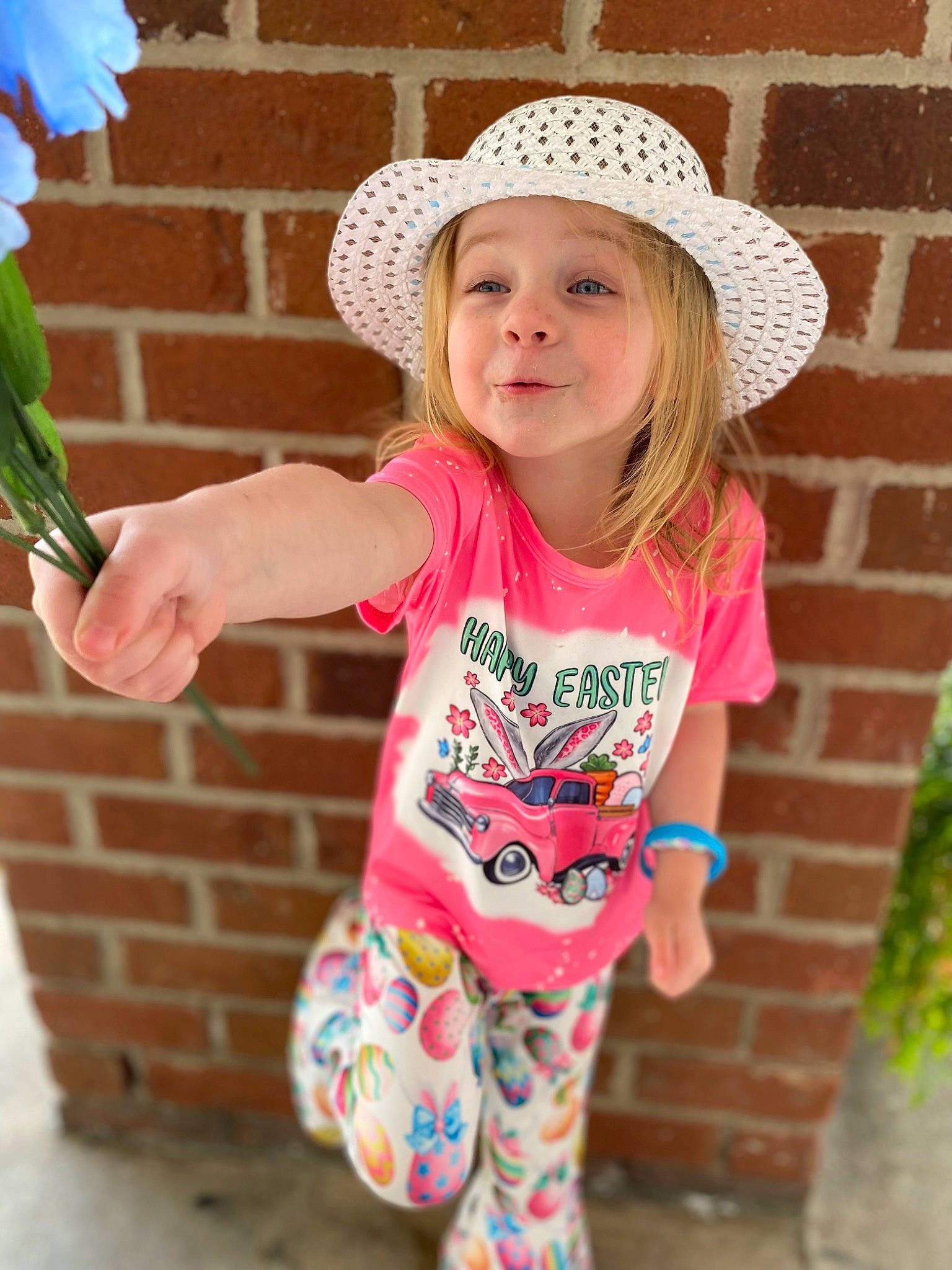 Mackena joined the competition — help win amazing prizes! baby_toddler_clothing, clothing, cool, face, facial_expression, flower, grass, green, happy, hat, headgear, headwear, joy, person, pink, plant, sleeve, smile, summer, sun_hat