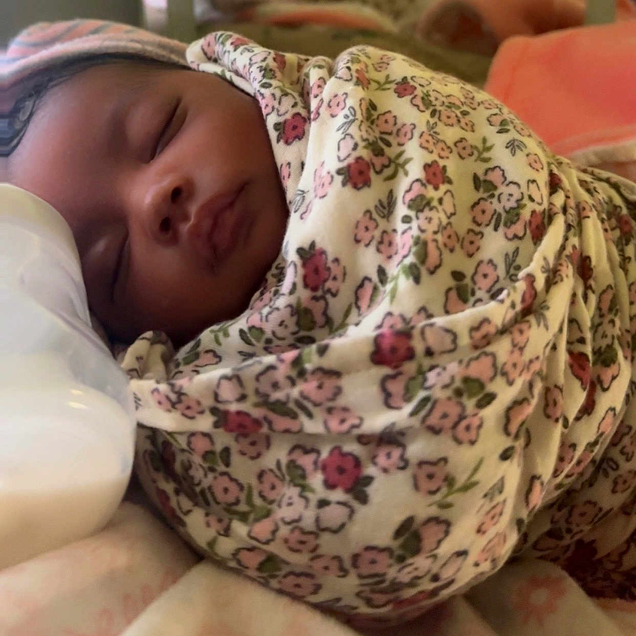 Amina joined the competition — help win amazing prizes! baby, sleeping, swaddled, blanket, floral_pattern, infant, peaceful, face, closeup, soft_lighting, bottle, nursery, newborn, cute, resting, cozy, portrait, child, indoors, tender_moment
