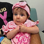 Brooklyn joined the competition — help win amazing prizes! baby, infant, child, portrait, face, eyes, wide_eyed, pink, striped_clothing, headband, bow, sitting, held, adult, arms, hands, indoors, chair, smiling, photography